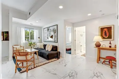 a living room with a couch and a table at Wynwood Jumbo - Sleeps 16 & free parking in Miami