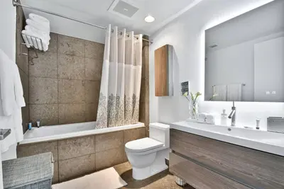 a bathroom with a tub and a toilet and a sink at Studio at Icon Brickell Luxury Waterfront Building in Miami