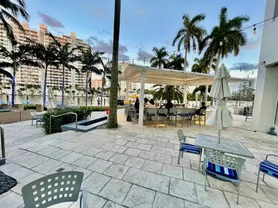 a patio with a table and chairs and an umbrella at Condo, Breathtaking Water views, King Suite, Hilton Property in Fort Lauderdale