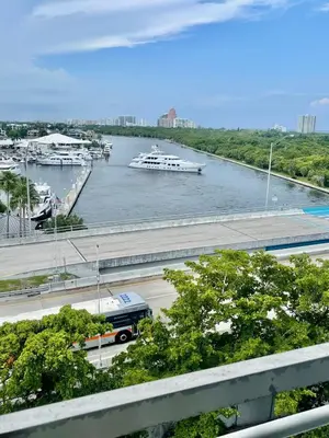 a bus driving down a highway next to a river with boats at Condo, Breathtaking Water views, King Suite, Hilton Property in Fort Lauderdale