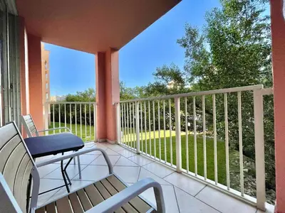 a balcony with a chair and a bench at Charming 2 bedroom 2 bathrooms at aventura in Miami