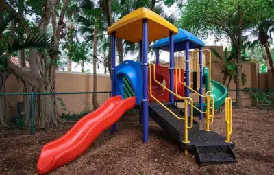 a playground with a slide in a park at Charming 2 bedroom 2 bathrooms at aventura in Miami