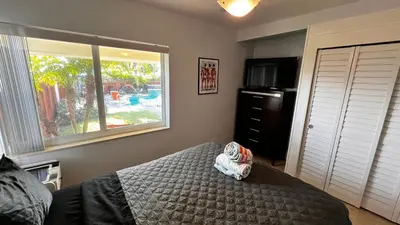 a bedroom with a bed and a window at Billy's Resort- Men Only - Solo Hombres in Wilton Manors