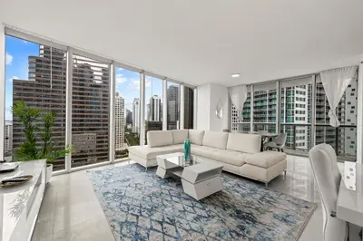 a living room with white furniture and large windows at LOVELY 2 BR W ICON BRICKELL-WATERVIEWS -FREE SPA in Miami