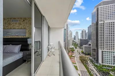 a balcony with a bed and a view of a city at LOVELY 2 BR W ICON BRICKELL-WATERVIEWS -FREE SPA in Miami