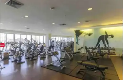 a gym with a lot of exercise equipment and a monkey on the wall at LOVELY 2 BR W ICON BRICKELL-WATERVIEWS -FREE SPA in Miami