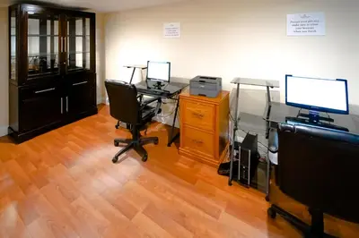 an office with two desks and two monitors and a computer at Fort Lauderdale Beach Resort by Vacatia in Fort Lauderdale