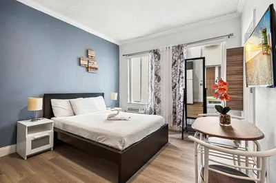 a bedroom with a bed and a table and a chair at Lovely condo in Miami Beach in Miami Beach