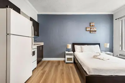 a bedroom with a bed and a blue wall at Lovely condo in Miami Beach in Miami Beach