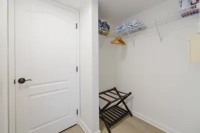 a room with a door and a chair and a shelf at Condo with Panoramic City Views in Brickell in Miami