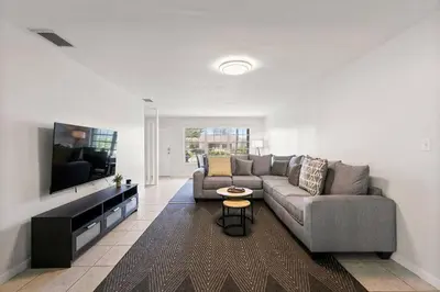 a living room with a couch and a flat screen tv at 3br Oasis near Coral Gable in Miami