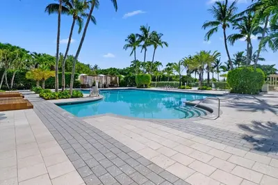 a swimming pool with palm trees in a resort at Stylish Suite to Have a Great Stay! in Miami