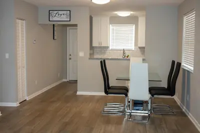 a dining room with a table and black chairs at Cozy and Modern Vacation Home in Hallandale Beach