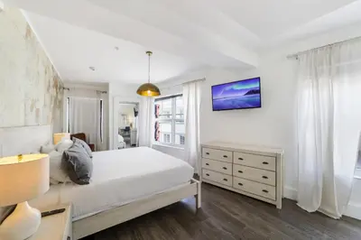 a bedroom with a white bed and a window at Ithaca in Miami Beach