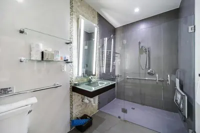 a bathroom with a glass shower and a sink at Ithaca in Miami Beach