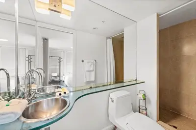 a bathroom with two sinks and a toilet at Ocean Drive Apartment Suites in Miami Beach in Miami Beach