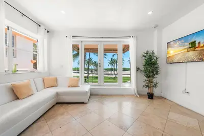 a living room with a white couch and a window at Ocean Drive Apartment Suites in Miami Beach in Miami Beach