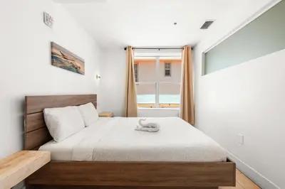 a bedroom with a bed and a window at Ocean Drive Apartment Suites in Miami Beach in Miami Beach