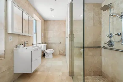 a bathroom with a shower and a sink and a toilet at Ocean Drive Apartment Suites in Miami Beach in Miami Beach