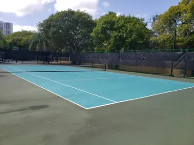 a tennis court with a tennis racket on it at Pet-Friendly Aventura Pool, Beach, Golf, Gym in Aventura