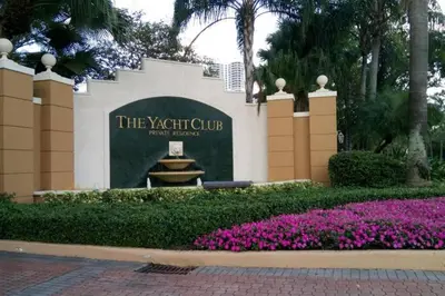 a sign for the yorkshire club with purple flowers at Pet-Friendly Aventura Pool, Beach, Golf, Gym in Aventura