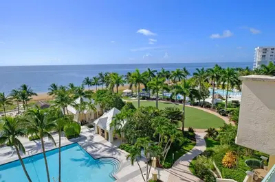 an aerial view of a resort with a swimming pool and the ocean at Leave the Worries Behind & Relax in Our Suite! in Miami