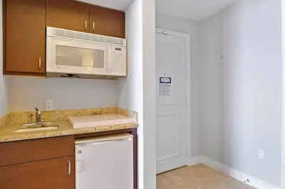 a kitchen with a sink and a microwave at Leave the Worries Behind & Relax in Our Suite! in Miami