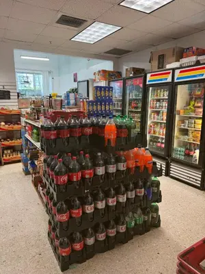 a display of soft drink bottles in a store at Condominium Sunny Isles Ocean Reserve in Sunny Isles Beach