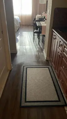 a kitchen and dining room with a rug on the floor at Departamento con salida al mar Miami in Sunny Isles Beach
