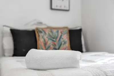 a white towel sitting on top of a bed at Biscayne Shore #2 - 3 2 - Charming and Tropical in Miami
