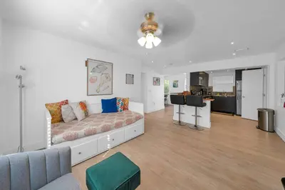 a living room with a couch and a kitchen at Biscayne Shore #2 - 3 2 - Charming and Tropical in Miami