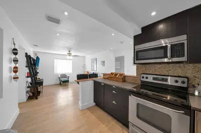 a kitchen with a stove and a microwave at Biscayne Shore #2 - 3 2 - Charming and Tropical in Miami