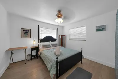 a bedroom with a bed and a desk in it at Biscayne Shore #2 - 3 2 - Charming and Tropical in Miami