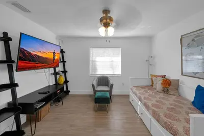 a living room with a couch and a tv at Biscayne Shore #2 - 3 2 - Charming and Tropical in Miami