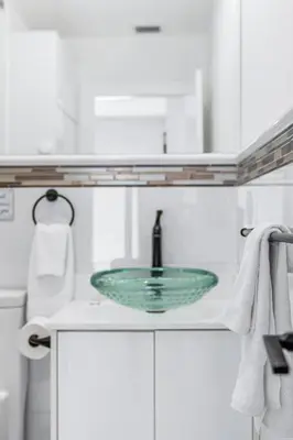 a bathroom with a glass sink and a toilet at 3 2 Family friendly Brand New Home w Pool in Miami