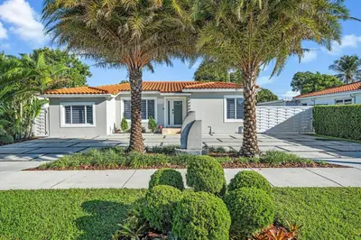 a white house with palm trees and a sidewalk at 3 2 Family friendly Brand New Home w Pool in Miami