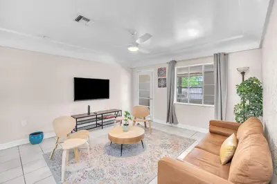 a living room with a couch and a table at Bluewave Bungalow - #2 Charming & Relaxing 2 1 in Dania Beach