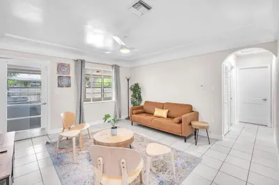 a living room with a couch and a table at Bluewave Bungalow - #2 Charming & Relaxing 2 1 in Dania Beach