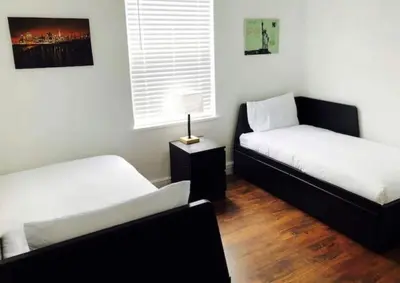 a room with two beds and a table with a lamp at Casa Havana Renovated 3 2-Near Brickell&Downtown in Miami