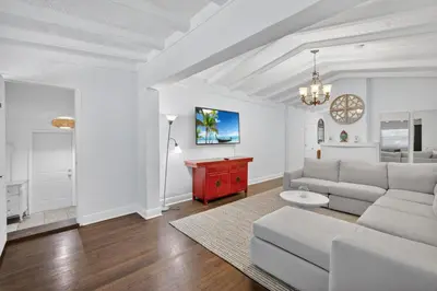 a living room with a white couch and a red cabinet at Casa Santorini - Chic 4 2 near Grove & Brickell in Miami