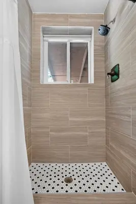 a bathroom with a shower with a window and a shower at Casa Santorini - Chic 4 2 near Grove & Brickell in Miami