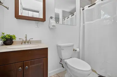 a bathroom with a toilet and a sink and a shower at Casa Santorini - Chic 4 2 near Grove & Brickell in Miami