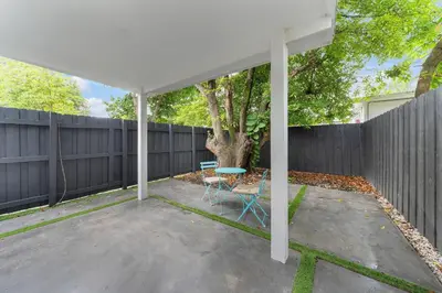 a patio with a table and a fence at Mykonos Home - 2 2 Cozy and Charming Duplex in Miami