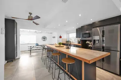 a kitchen with a large island with bar stools at Renovated Gem: Prime Spotless Ideal in Miami