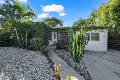 a house with a cactus in the yard at Renovated Gem: Prime Spotless Ideal in Miami