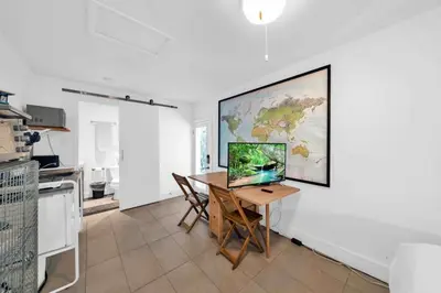 a dining room with a table and a map on the wall at Renovated Gem: Prime Spotless Ideal in Miami