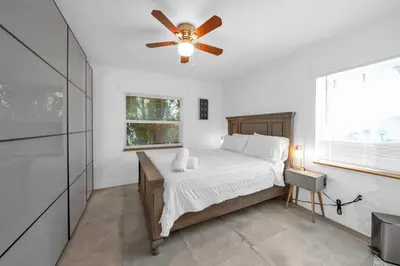 a bedroom with a bed with a ceiling fan at Renovated Gem: Prime Spotless Ideal in Miami