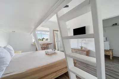 a bedroom with a bunk bed and a table at Treehouse Hotel in Miami