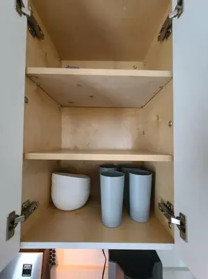 a cupboard with two white bowls and shelves at West Brickell APT #1 Free Parking-Family Friendly in Miami