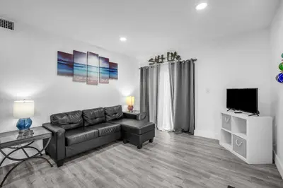 a living room with a couch and a flat screen tv at West Brickell APT #1 Free Parking-Family Friendly in Miami